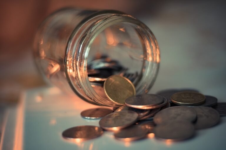 A glass jar filling with coins, a reminder that smart buying lowers your cooking gas costs