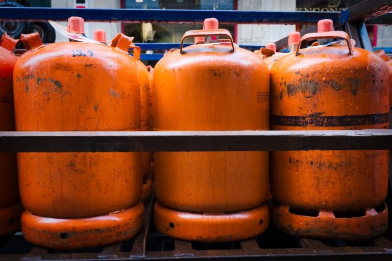Stacked gas cylinders on a rack, representing a cooking gas supply business