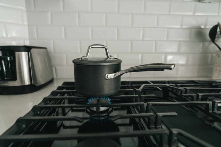 A pot cooking on a blue gas flame, a home switching to cooking gas