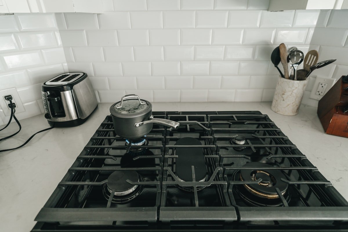 A gas stovetop in a kitchen, where a gas smell should always be taken seriously