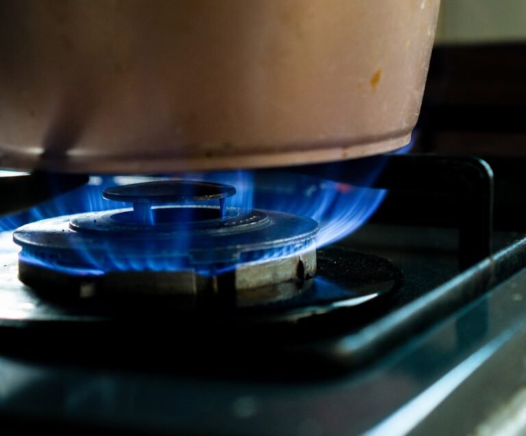 A calm, steady blue flame on a gas stove in a home kitchen