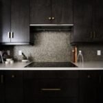 A dark ceramic induction stovetop in a modern kitchen
