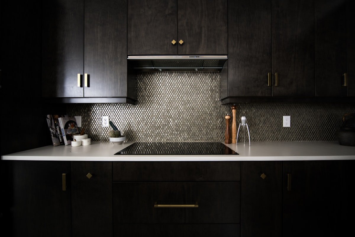 A dark ceramic induction stovetop in a modern kitchen
