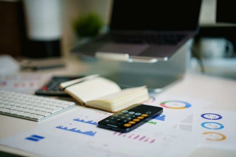 Calculator and financial records used for small business cost calculations