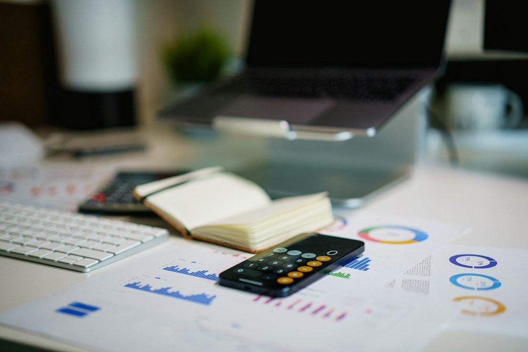 Calculator and financial records used for small business cost calculations