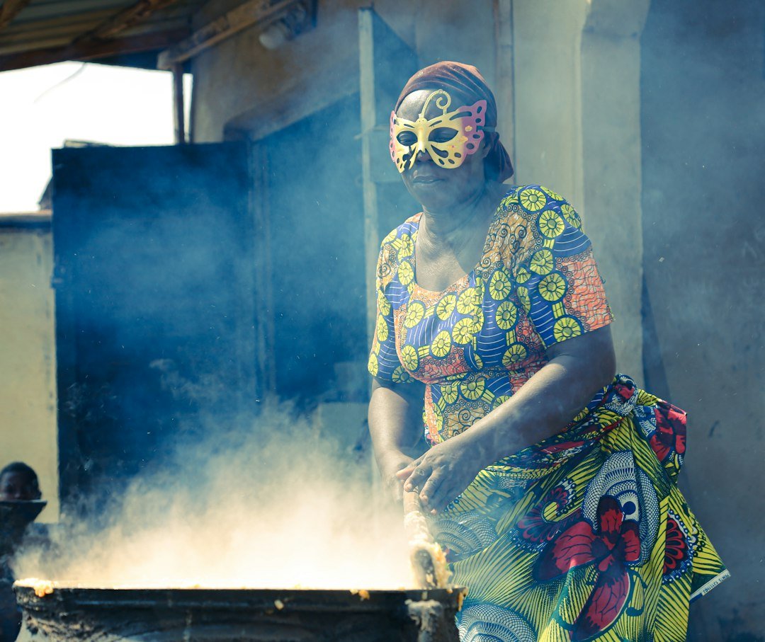 Woman cooking with a gas stove in a household setting