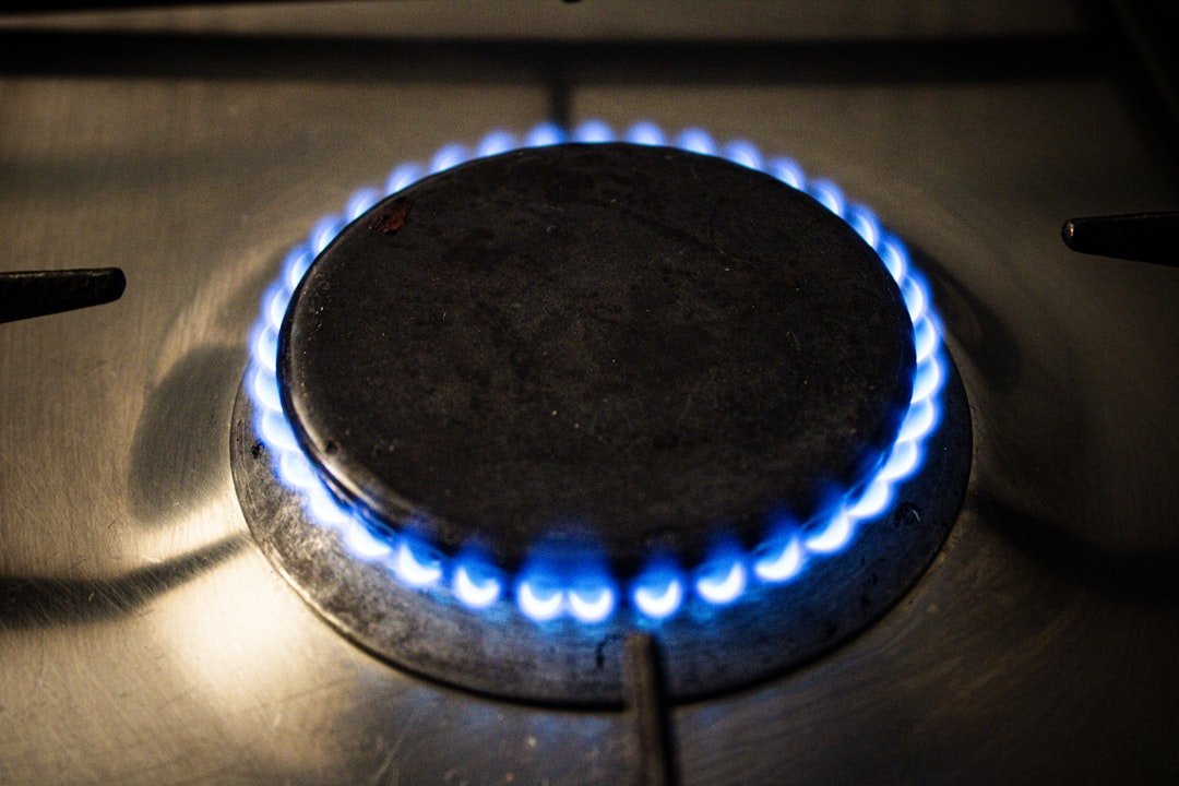 Blue gas cooker flame on a stove burner in a kitchen