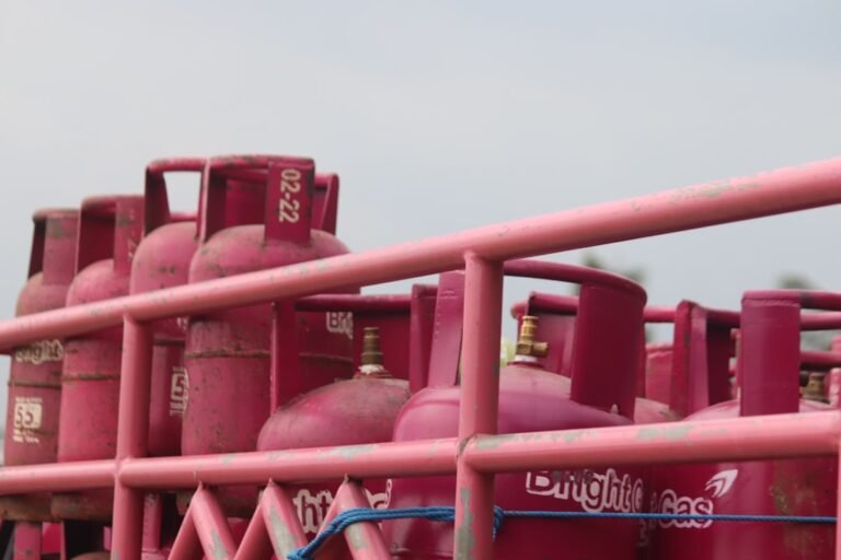 Cooking gas cylinder being handled for LPG refill and delivery