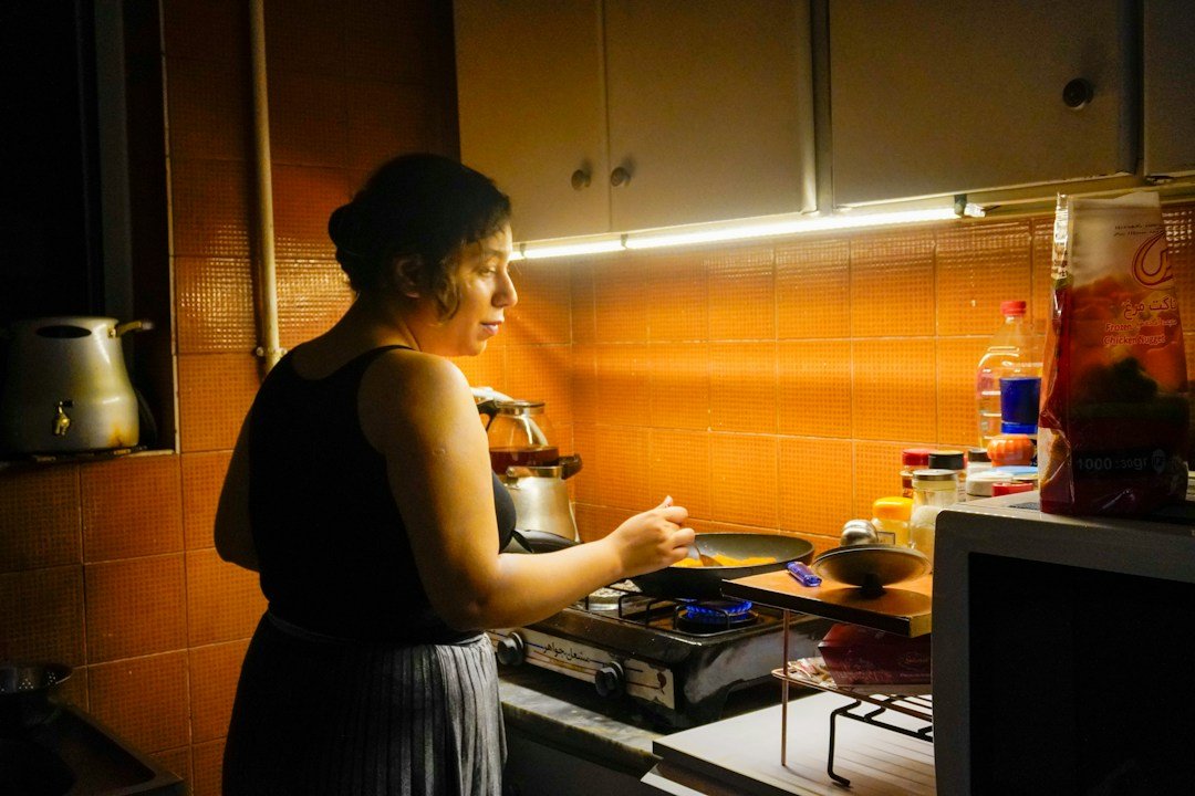 Woman cooking on a gas stove in a home kitchen
